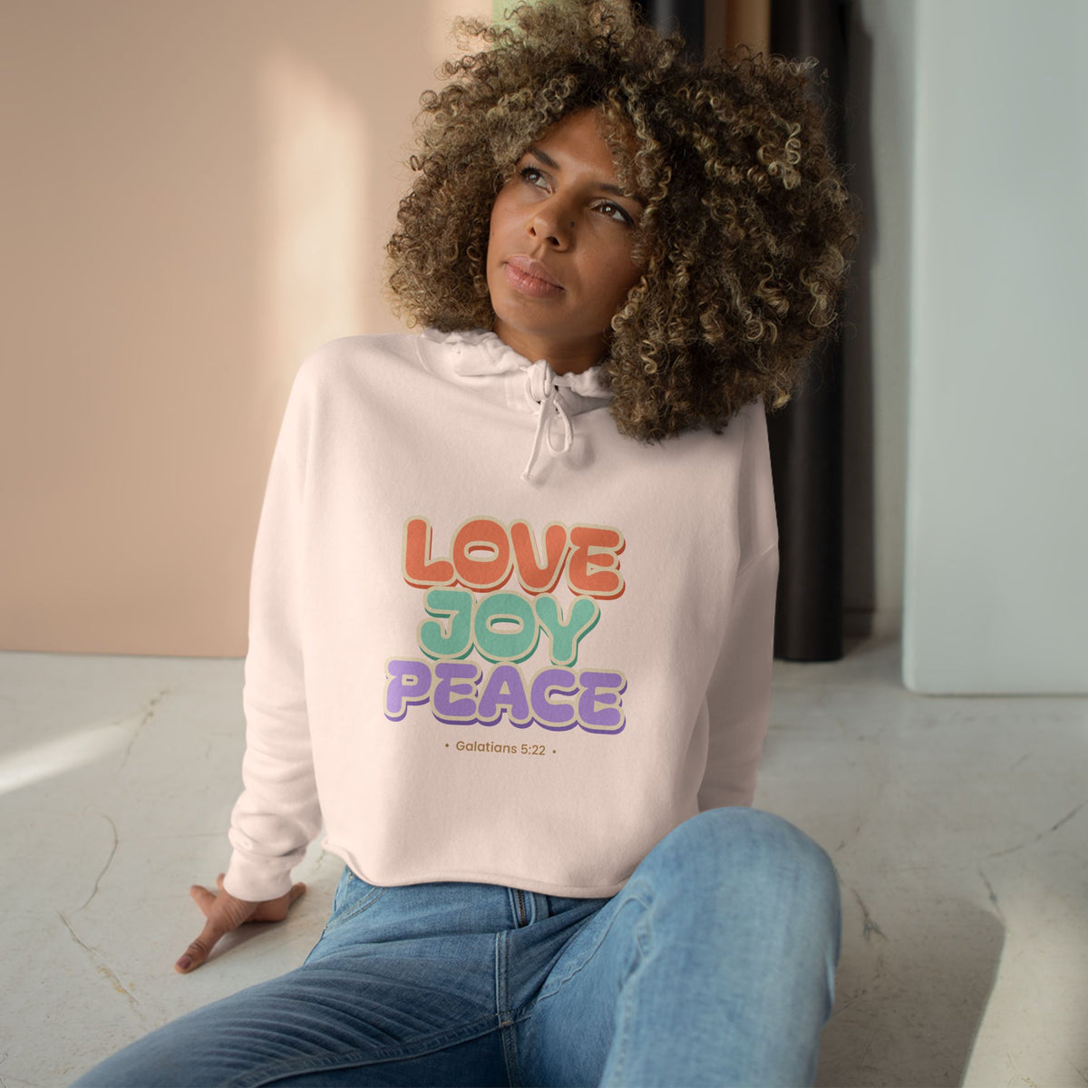 Love Joy Peace Crop Hoodie, crop hoodie, Pale Pink, front view, worn by a woman, LOVE. JOY. PEACE., Galatians 5:22 (KJV)